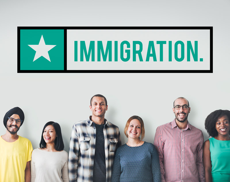 immigration sign and line up of diverse group of adults